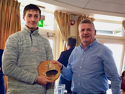 Ewan McMahon is presented the Seaward Bell Trophy by Kevin Darmody