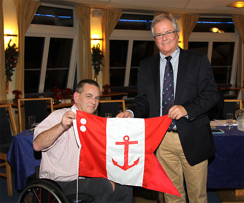 Feargal Kinsella accepts his Rear Commodore's burgee from Commodore Berchmans Gannon