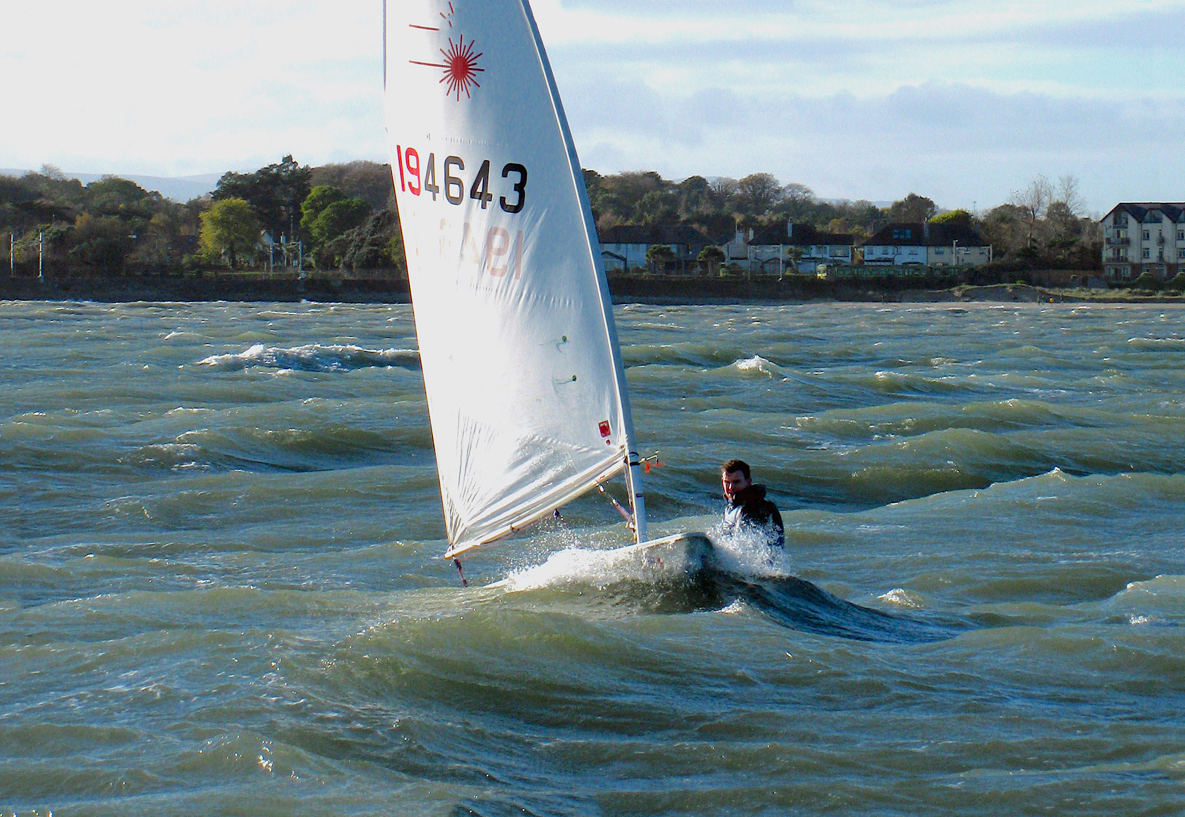 Conor Murphy tackles the swell in his Laser