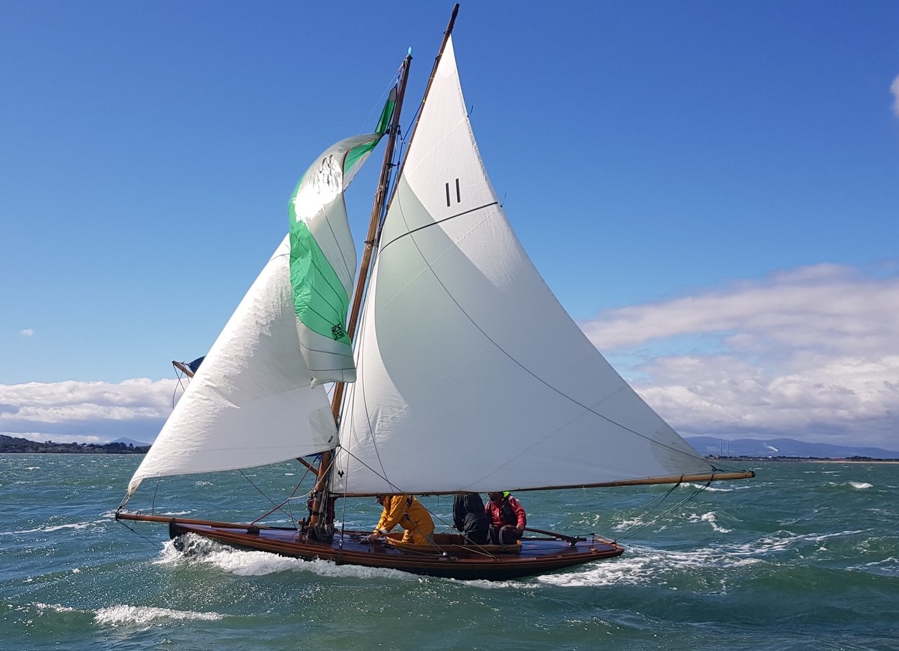 Friday night's race winner 'Deilginis' hoists her spinnaker in the fresh breeze