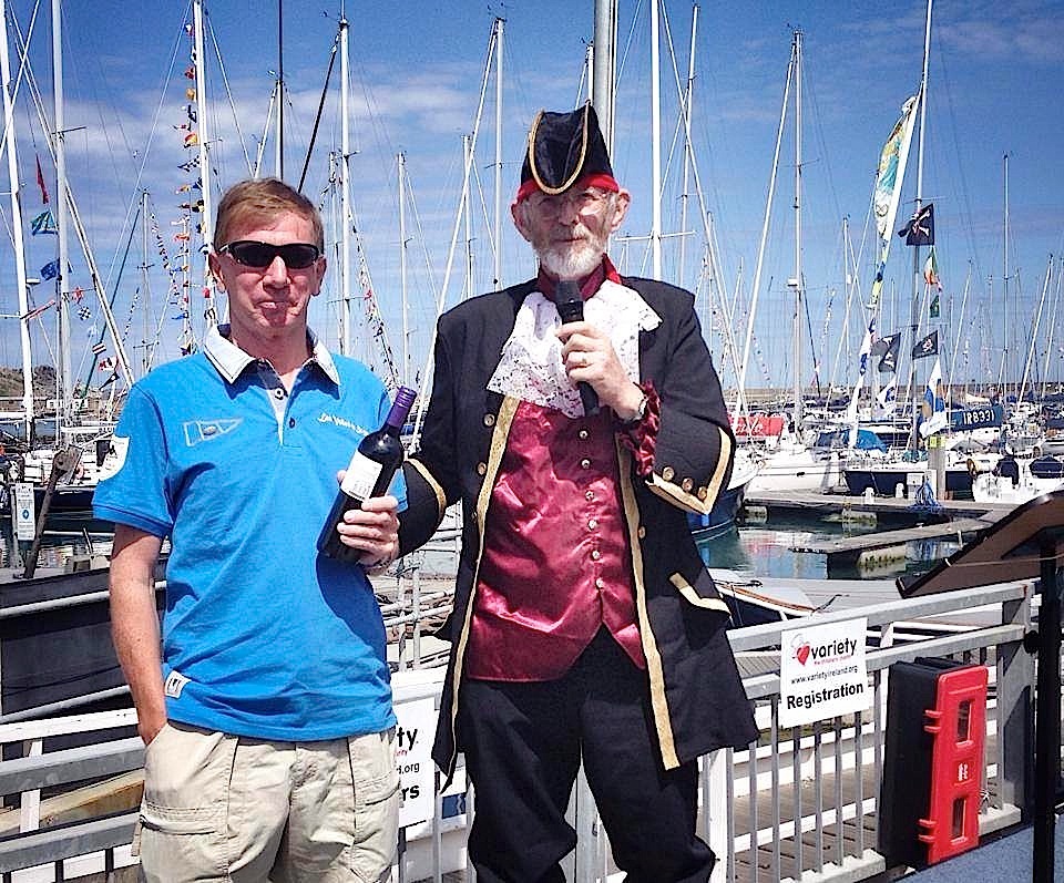 'Changeling's' Kieran Jameson collects the prize from Pat for Best Dressed Boat (background right)